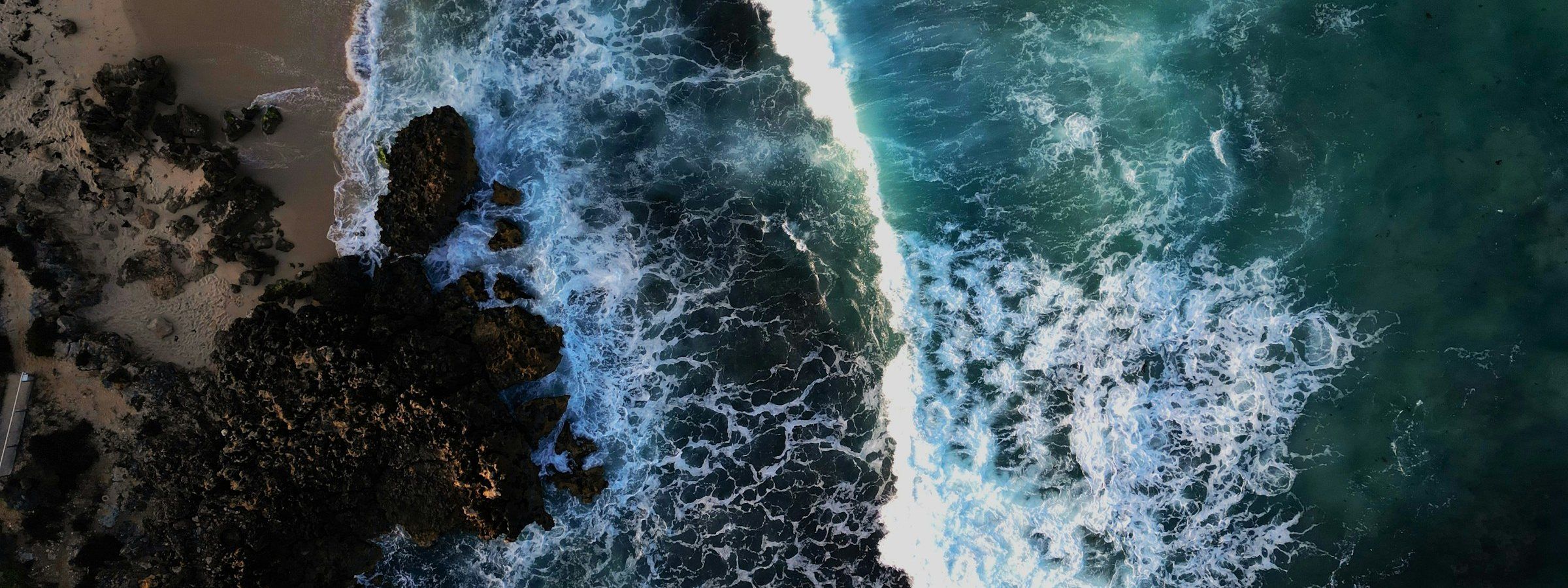 An aerial view of the sea meeting a beach. Stock photograph.