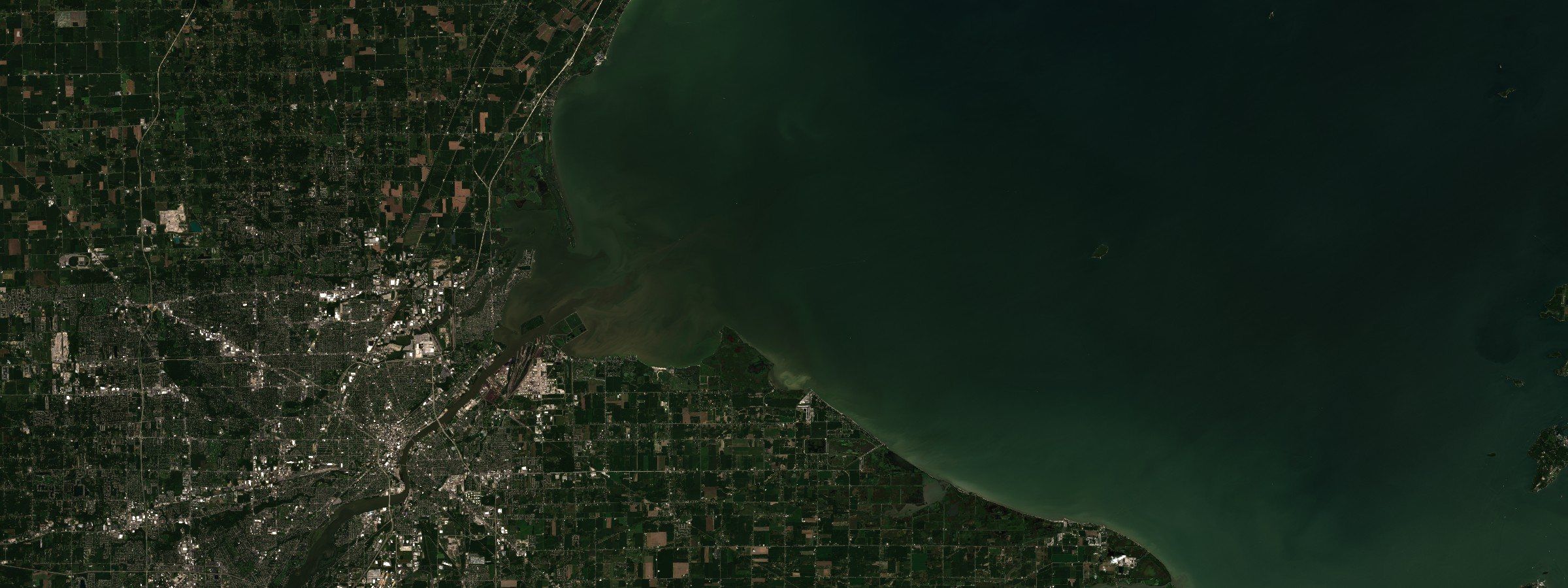 Sentinel-2 L2A surface reflectance, bands B04/B03/B02. Maumee Bay and the Toledo shoreline, western Lake Erie, 28 August 2026. A bloom's colour is its size. Whether the water at the intake is toxic is the second measurement, and no satellite takes it.